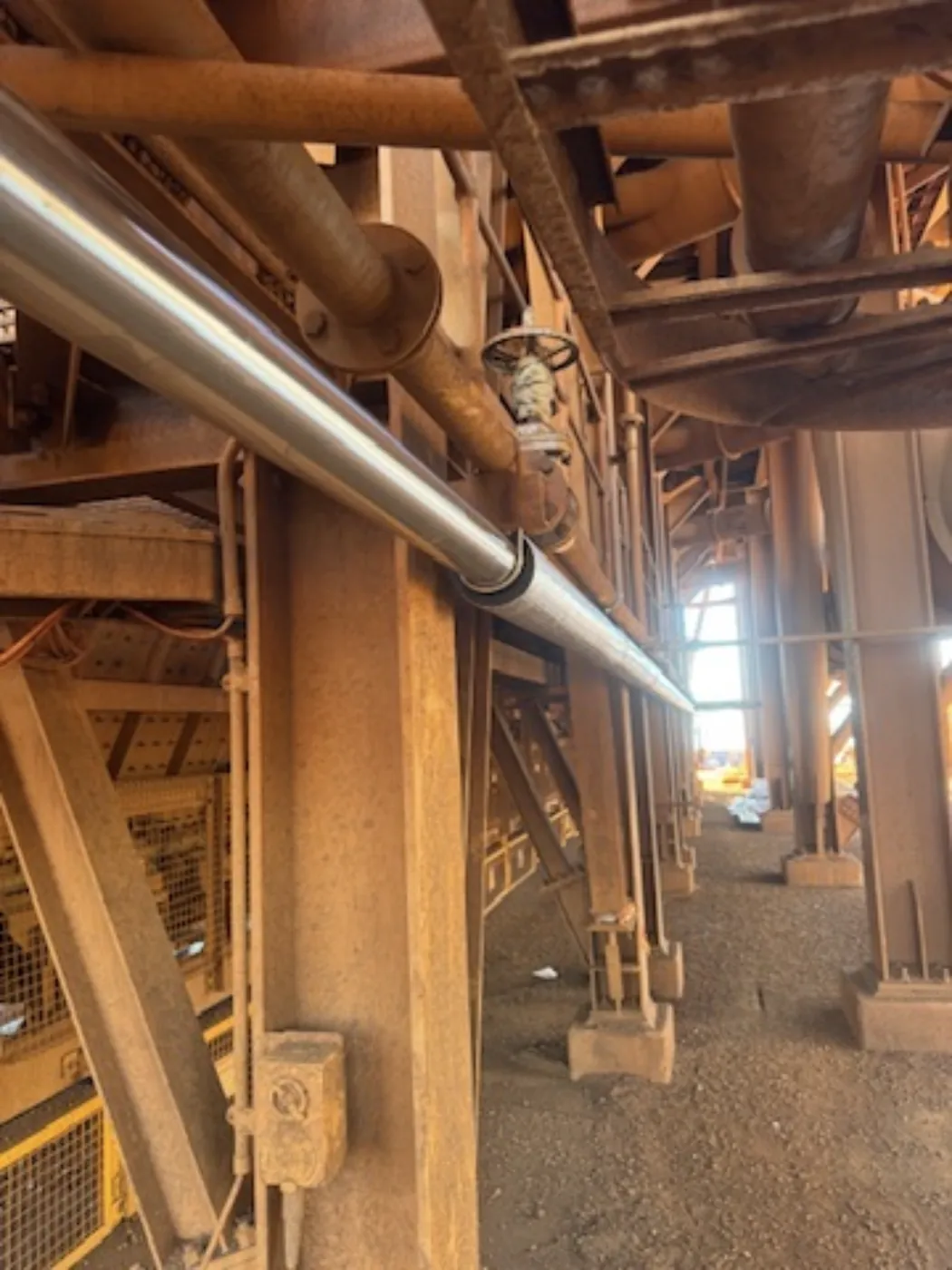 A stainless pipe run through a mine process plant